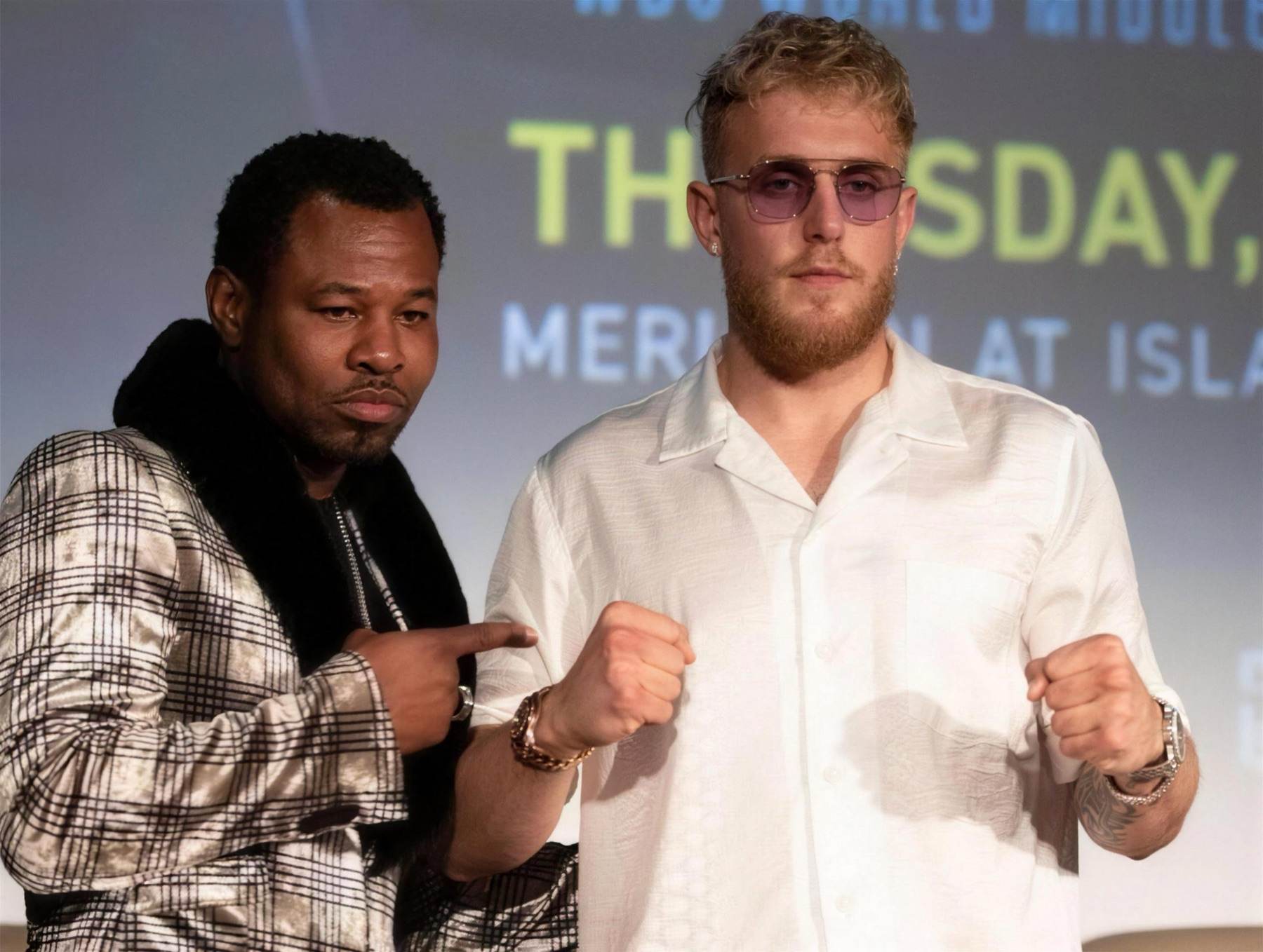 Shane Mosley pointing at Jake Paul on stage at a press conference
